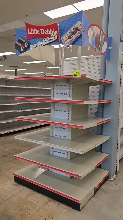 Little Debbie merchandiser end cap display. Features (5) upper shelves, 16" base shelf, red shelf channel molding, and 'Little Debbie Unwrap A Smile!'