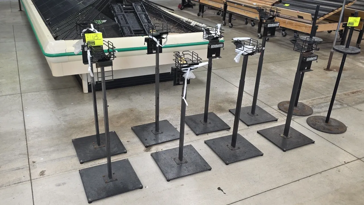 Twist-Ease metal bag and twist tie floor stands. Features wire basket produce bag holders, integrated Twist-Ease twist tie dispensers, and square weig