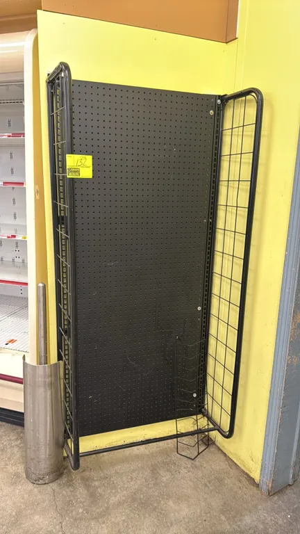 Metal wall-mount pegboard merchandiser. Features black pegboard backing, slotted upright standards, and wire grid side panels. Dimensions: 30" x 66".