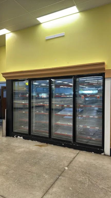 Foam panel walk-in dairy cooler. Features (4) glass display doors, 8' x 8' double swing entry doors, (4) Bohn evaporator coils, and interior lighting.