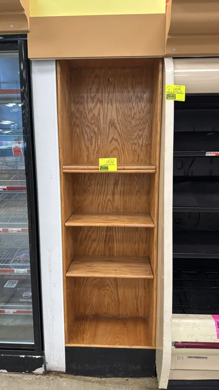Oak 5-tier merchandiser. Features wood construction with an oak finish and a black toe-kick base. 23"W x 13"D x 77"H. Adjacent display cases not inclu