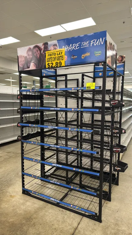 3-way multi-tier end cap merchandiser. Features black coated metal construction, multi-tier wire shelves with price channel strips, side-mounted hangi