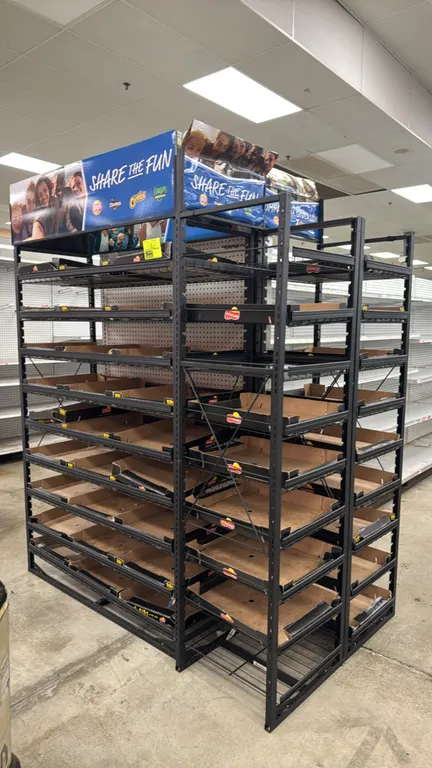 Metal 3-way multi-tier end cap merchandiser display rack. Features black coated metal frame, multi-tier wire display shelves with price channel strips