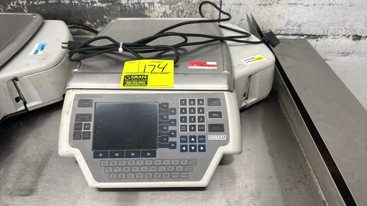 Hobart Quantum electronic scale with integrated label printer. Features 30 lb capacity, stainless steel weighing platter, digital display, numeric key