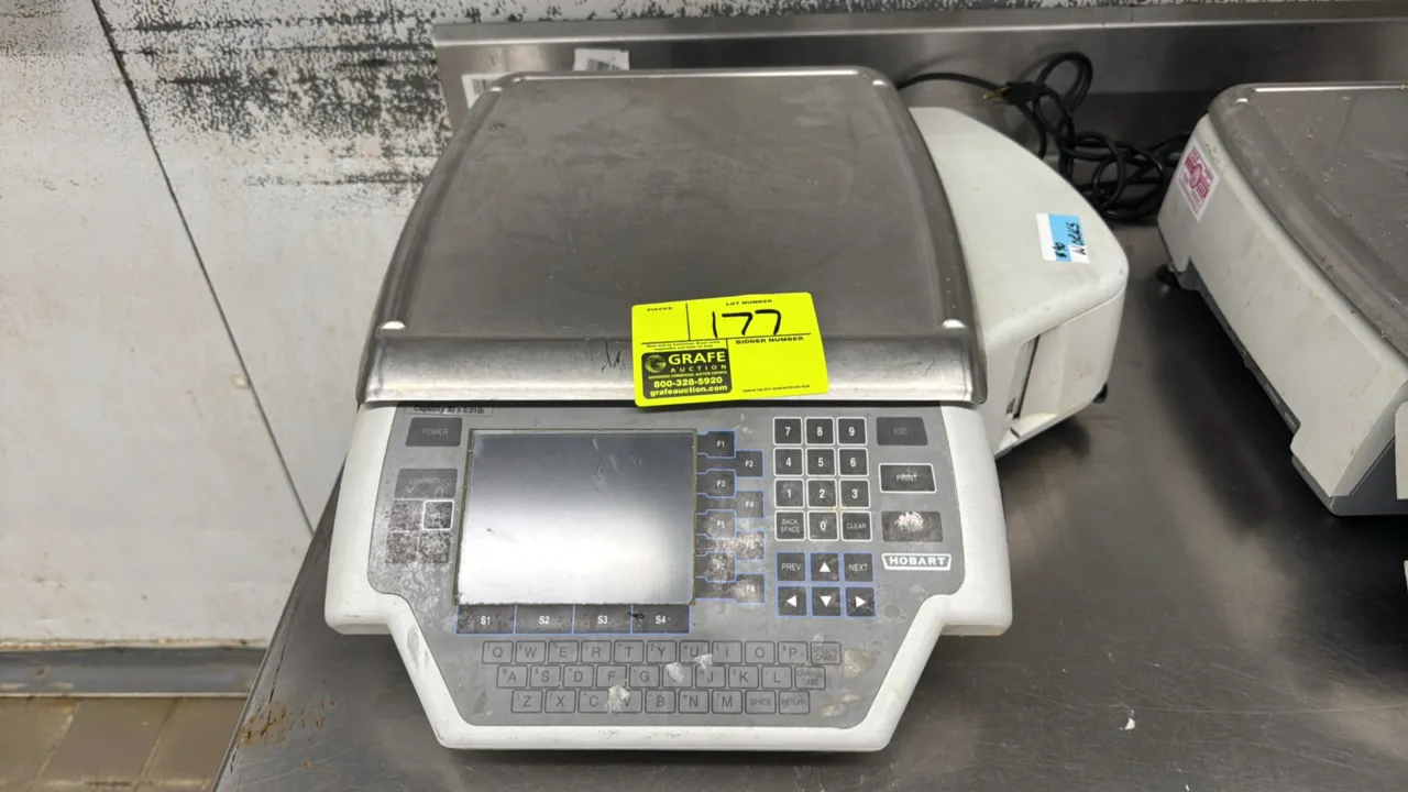 Hobart Quantum electronic scale with label printer. Features 30 lb capacity, stainless steel weigh platter, digital display, and keypad. S/N: 31-1381-
