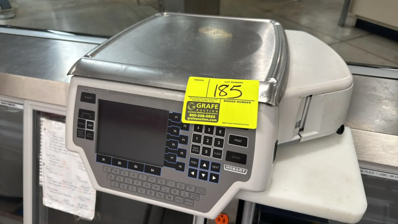 Hobart Quantum electronic scale with label printer. Features 30 lb capacity (30 x 0.01 lb), stainless steel weighing platter, integrated thermal label