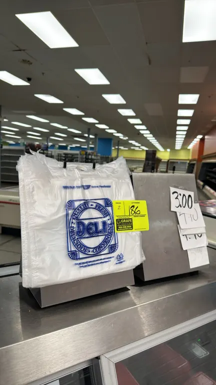 Stainless steel deli bag holders. Features stainless steel construction, dual bag hanging prongs, and angled countertop bases. Contents not included.