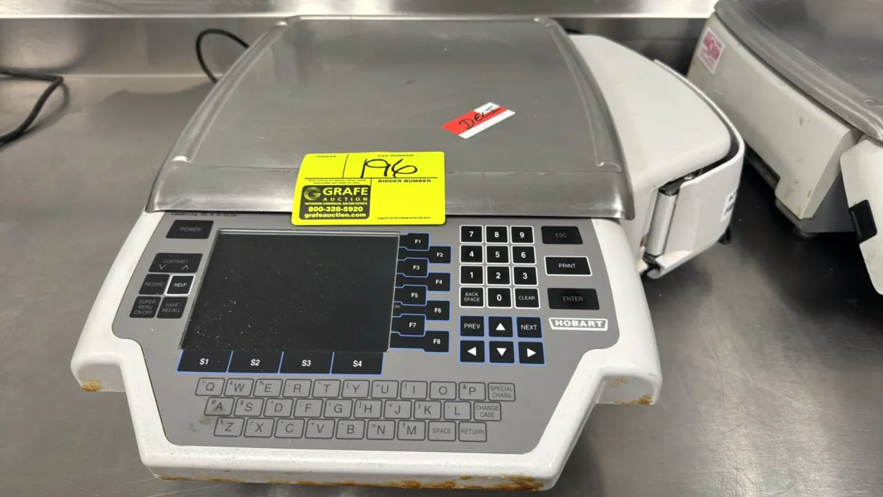Hobart Quantum-1 30 lb electronic scale with label printer. Features stainless steel platter, digital display, alphanumeric membrane keypad, and integ