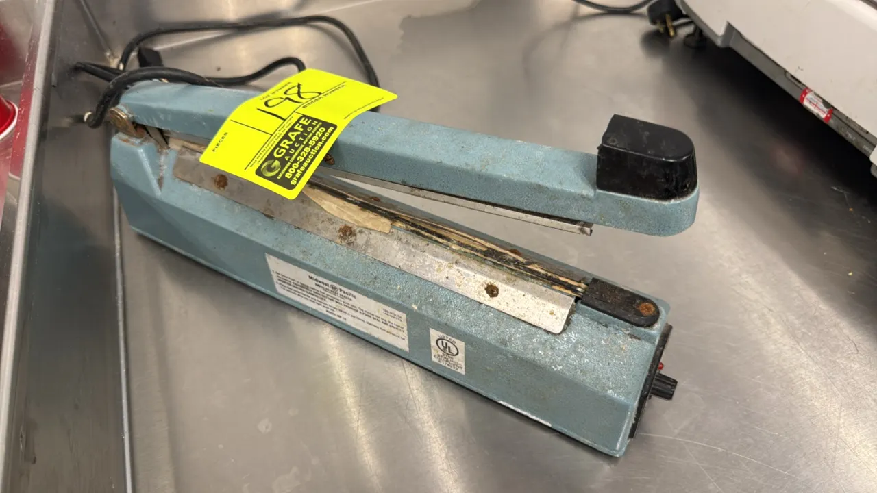 Midwest Pacific MP-12 impulse heat sealer. Features manual lever operation, adjustable timer control dial, and indicator light. 12" sealing length. El