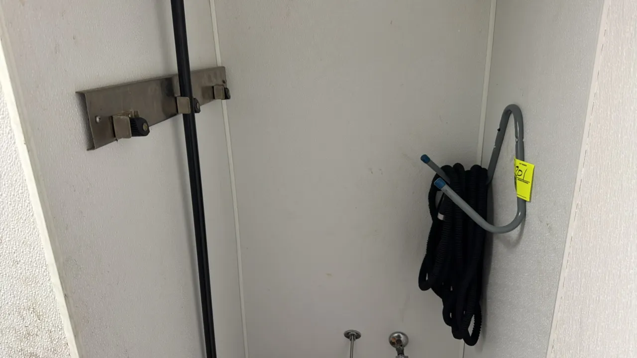 Package lot of cleaning storage accessories. Includes a wall-mounted metal hose hanger with black expandable hose, and a stainless steel wall-mounted