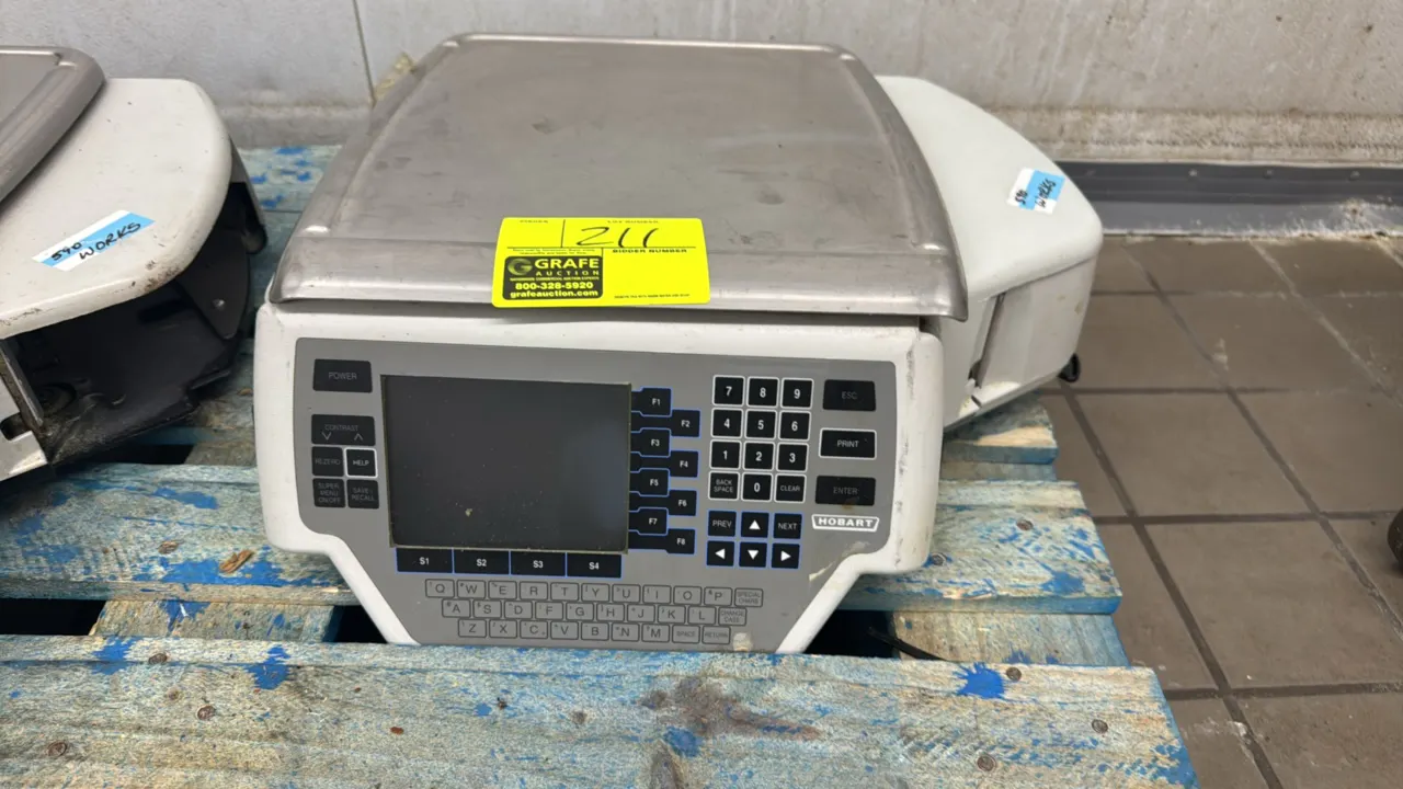 Hobart Quantum electronic scale with label printer. Features 30 lb capacity, stainless steel platter, digital display, membrane keypad, and integrated