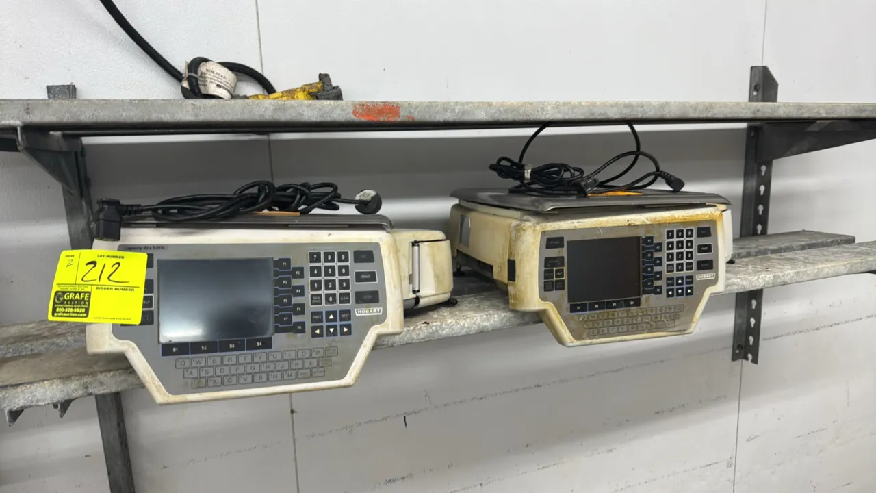 Hobart Quantum electronic scales. Features 30 lb capacity, integrated label printers, stainless steel weighing platters, digital display screens, and