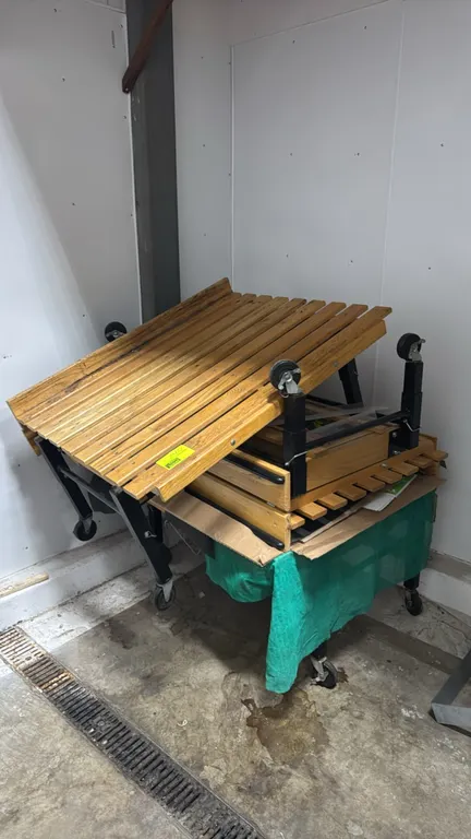 Wood and metal portable produce display tables. Features slatted wood display tops and black metal frames. 48" x 40". Mounted on casters.