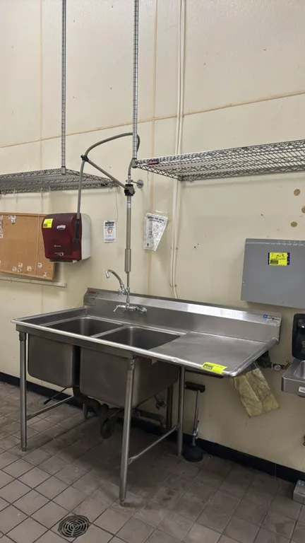 Eagle Group stainless steel 2-compartment sink. Features right drainboard, backsplash, splash-mount pre-rinse faucet with add-on spout, and lever wast