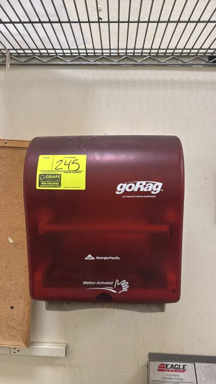 Georgia-Pacific goRag automated wiper dispenser. Features touchless motion-activated dispensing and a translucent red plastic housing. Wall mounted.