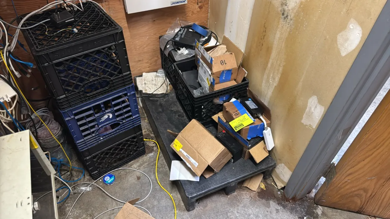 Package lot of assorted IT equipment and accessories. Includes plastic crates, backup batteries, network cords and cables, power supplies, Ubiquiti ne