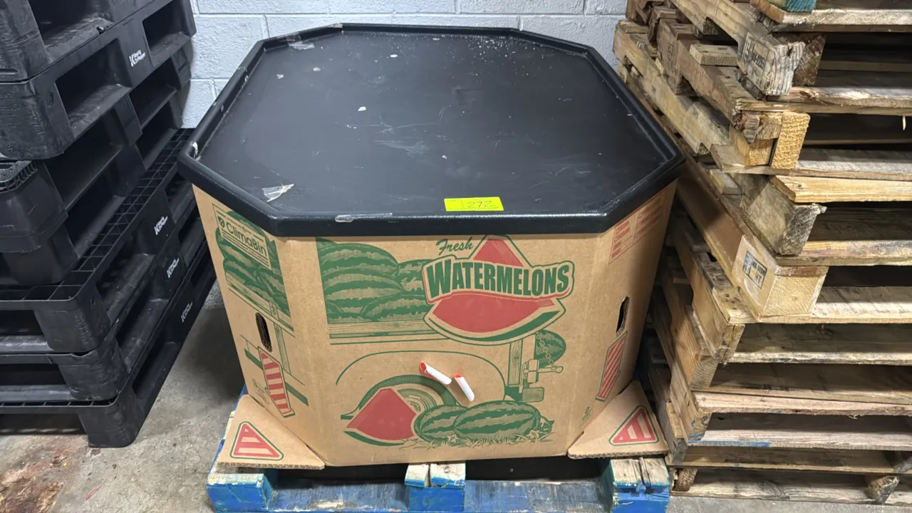 Corrugated produce display bin with polyethylene merchandising top. Features octagonal watermelon bin construction and a black molded poly merchandisi