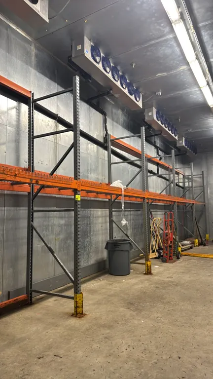 Interlake pallet racking. Features 5" crossbars and wire metal decking. Dimensions: 9'L x 3 1/2'D x 12'H per section. Foreground equipment, carts, and