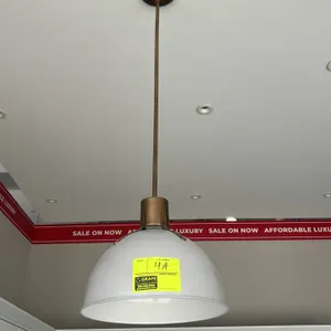 Ceiling hanging pendant light fixture. Features a white dome shade with brass-finish hardware, downrod, and round ceiling canopy. Hardwired mounting. 