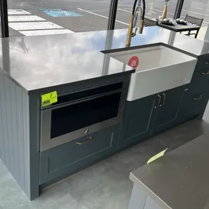 Infinity Plus laminate kitchen cabinet set and island. Includes upper and lower wall cabinets, display hutch with reeded glass doors, solid surface co