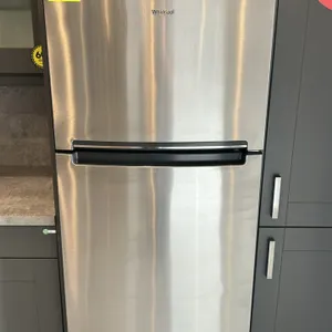2022 Whirlpool WRT518SZFM02 top-freezer refrigerator. Features stainless steel finish, upper freezer compartment, glass shelving, crisper drawers, doo