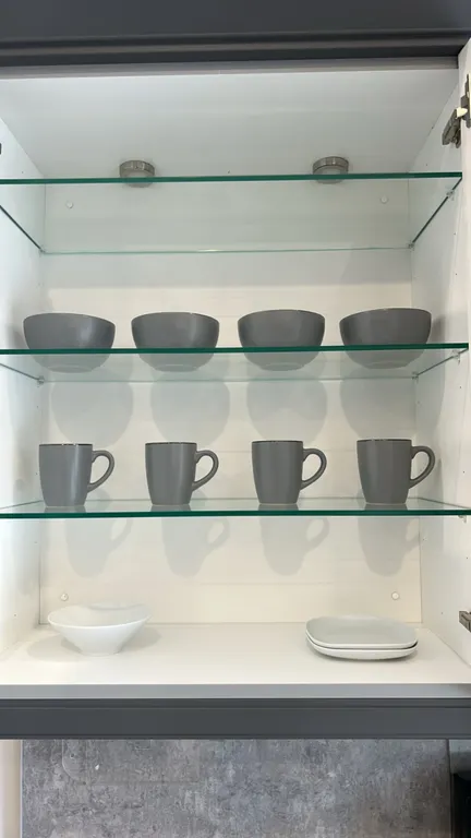 Assorted kitchen smallwares. Includes ceramic dinnerware with (4) mugs, (4) bowls, (4) salad plates, and (4) dinner plates, plus additional white cera