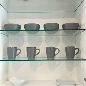 Assorted kitchen smallwares. Includes ceramic dinnerware with (4) mugs, (4) bowls, (4) salad plates, and (4) dinner plates, plus additional white cera