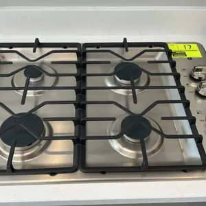 GE JGP3030SL2SS 4-burner gas cooktop. Features stainless steel construction, cast grates, and right-side dial controls with Power Boil burner. S/N: GV