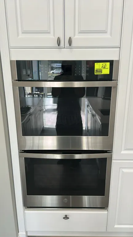 GE JTD3000SN2SS smart built-in double wall oven. Features stainless steel finish, glass viewing windows, digital touch controls, and interior wire rac