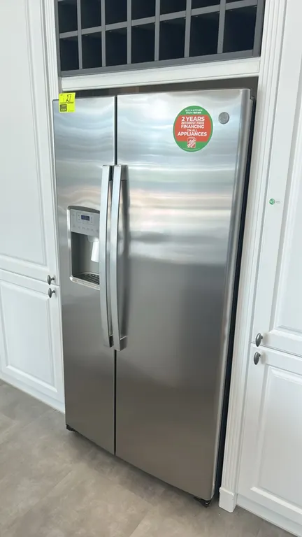 GE Appliances GZS22IYNXHFS side-by-side refrigerator and freezer combo. Features stainless steel finish, exterior water and ice dispenser, interior gl