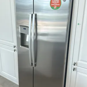 GE Appliances GZS22IYNXHFS side-by-side refrigerator and freezer combo. Features stainless steel finish, exterior water and ice dispenser, interior gl