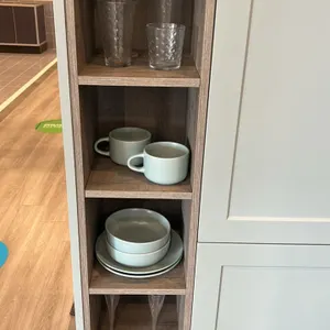 Assorted kitchen smallwares and decor. Includes ceramic dinnerware plates, bowls, and mugs, glassware and stemware, decorative bottles, wooden serving