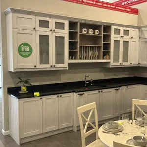 Infinity Plus laminate kitchen cabinet set. Features white shaker-style cabinetry, frosted glass doors, integrated plate rack, corner pantry, open she
