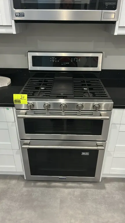 Maytag MGT8800FZ 30" double oven gas range. Features stainless steel exterior, 5-burner cooktop with continuous cast iron grates, center griddle, True