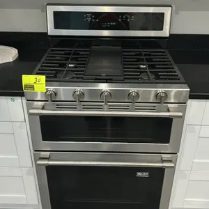 Maytag MGT8800FZ 30" double oven gas range. Features stainless steel exterior, 5-burner cooktop with continuous cast iron grates, center griddle, True