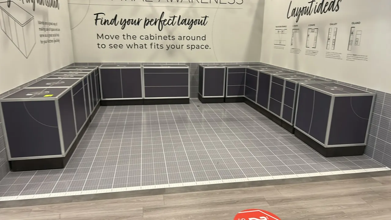 Modular base cabinet showroom display units. Features aluminum extrusion frames, dark gray laminate panels, labeled tops, and raised toe kicks. Includ