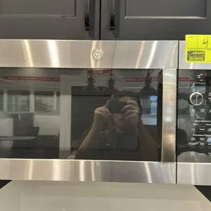 2023 GE Profile PVM9215SK6SS over-the-range microwave oven. Features stainless steel finish, glass turntable, digital controls with selector dial, and