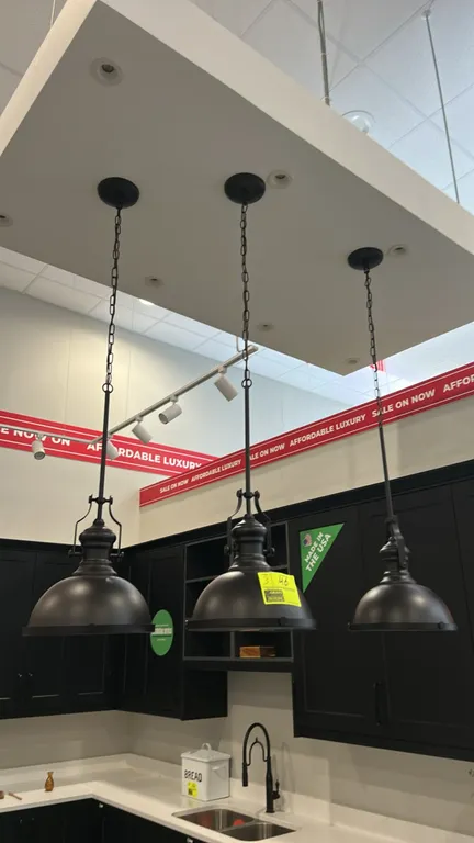 Bronze metal dome ceiling hanging pendant lights. Features industrial-style dome shades with dark bronze finish, frosted glass bottom diffusers, decor