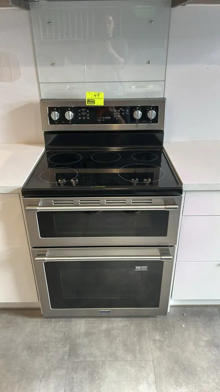 Maytag MET8800FZ freestanding electric double oven range. Features a stainless steel finish, smooth glass cooktop with radiant elements and warming ce