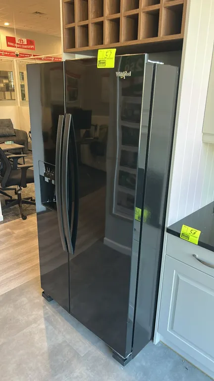 2023 Whirlpool WRS325SDHB08 side-by-side refrigerator and freezer combo. Features exterior water and ice dispenser, glass shelving, clear storage draw