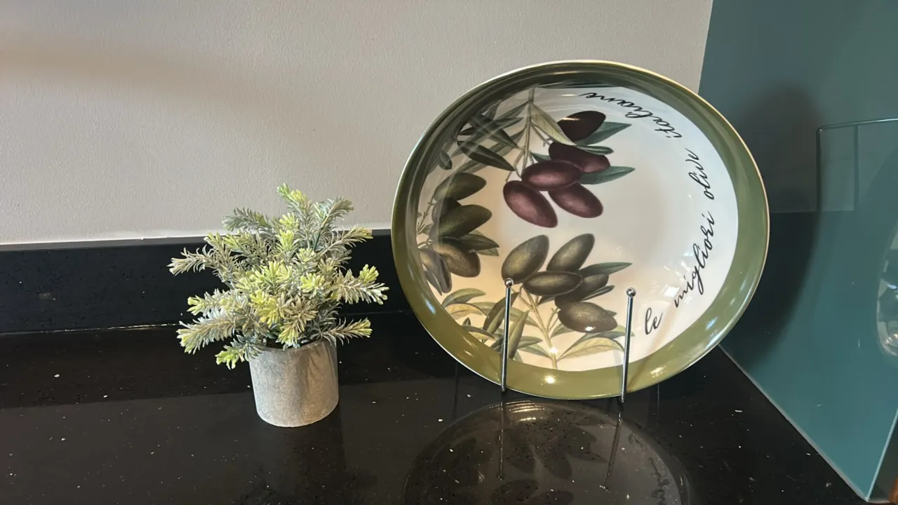 Assorted kitchen smallwares and dinnerware. Includes white ceramic baking dish, white plates and bowls, olive pattern serving bowl with stand, olive a