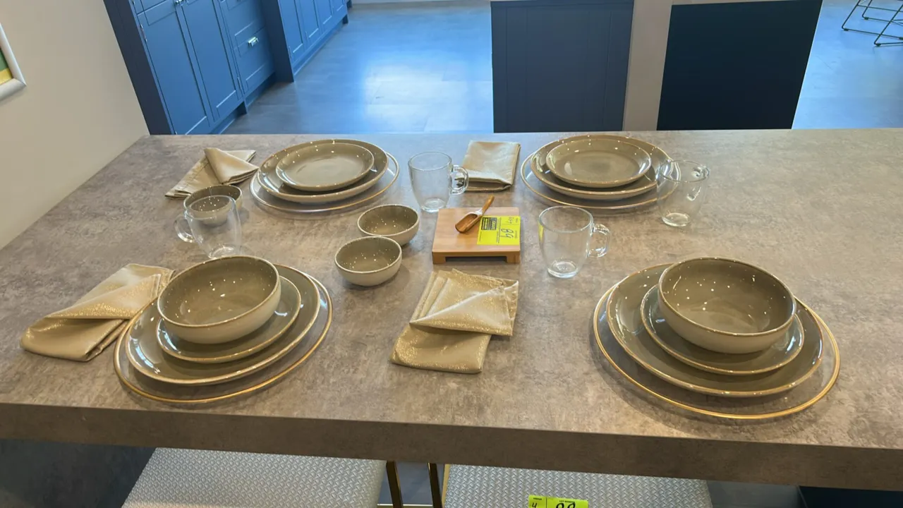 Assorted tableware and decorative smallwares. Includes ceramic dinner plates, salad plates, bowls, condiment dishes, circular metal chargers, clear gl