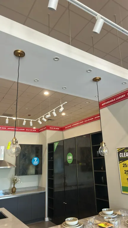 Ceiling hanging pendant lights. Features clear glass globe shades, antique brass-tone socket fixtures, matching round ceiling canopies, and black cord