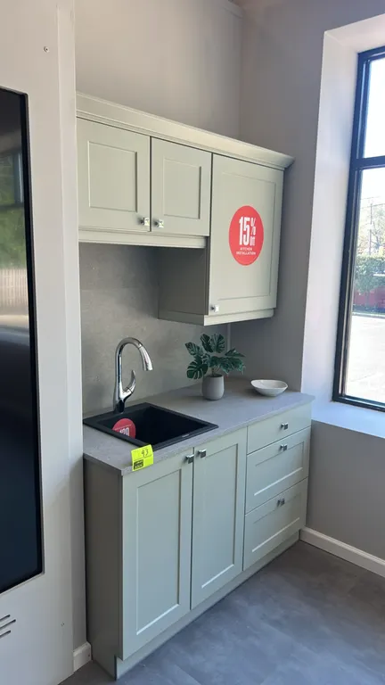 Infinity Plus laminate kitchen cabinet set. Features shaker-style upper and lower cabinets, laminate countertop, Bocchi black drop-in sink, and single
