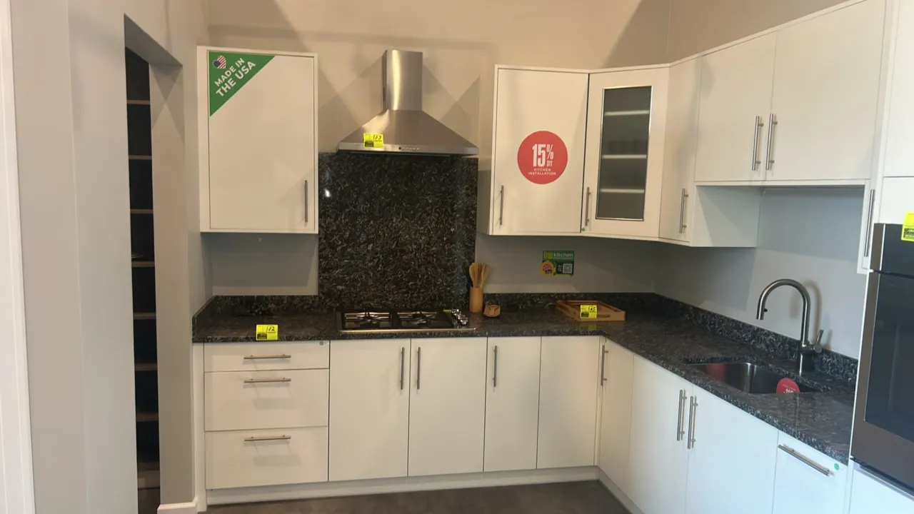 Infinity Plus laminate kitchen cabinet set. Features white laminate construction, solid surface countertops, stainless steel sink, and stainless steel