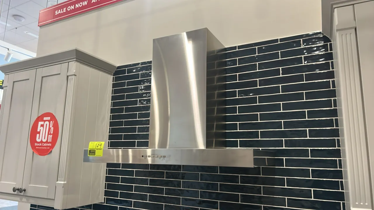 GE Appliances UVW8361SL1SS designer wall-mount range hood. Features stainless steel finish with chimney flue, electronic push-button controls, undermo
