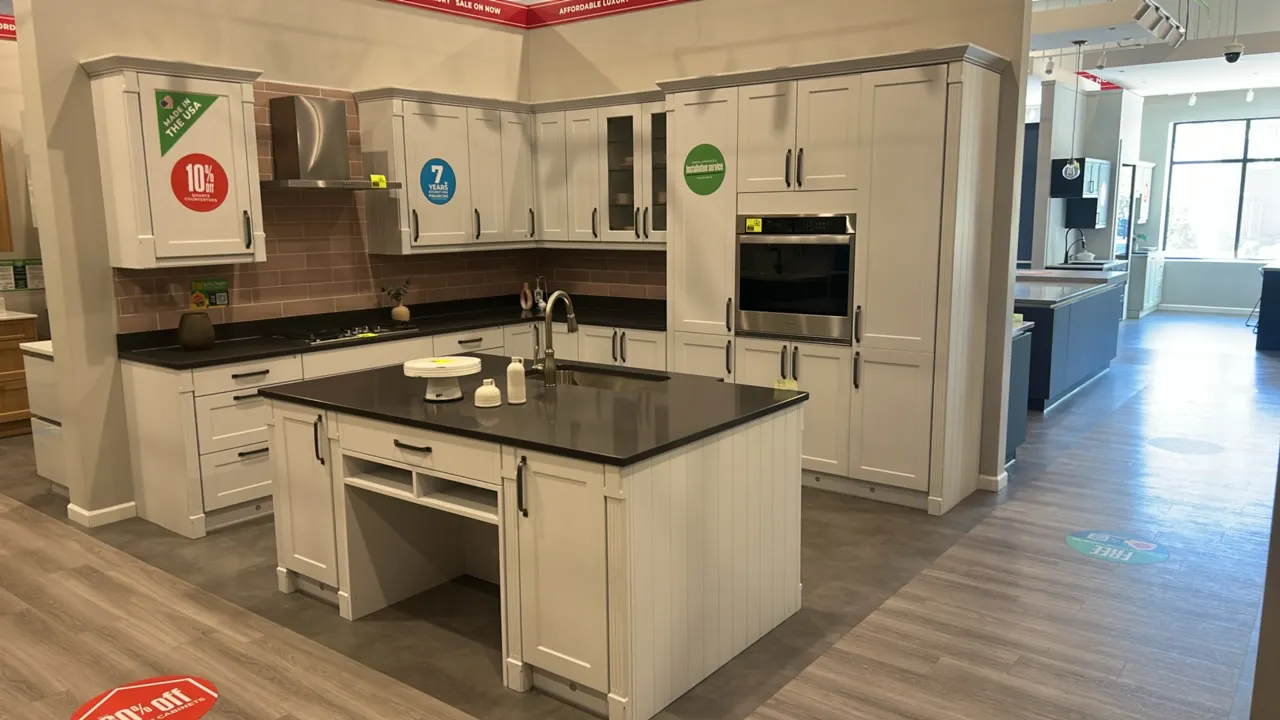 Infinity Plus kitchen cabinet set and island. Features white laminate cabinetry, solid surface countertops, undermount stainless steel sink, and stain