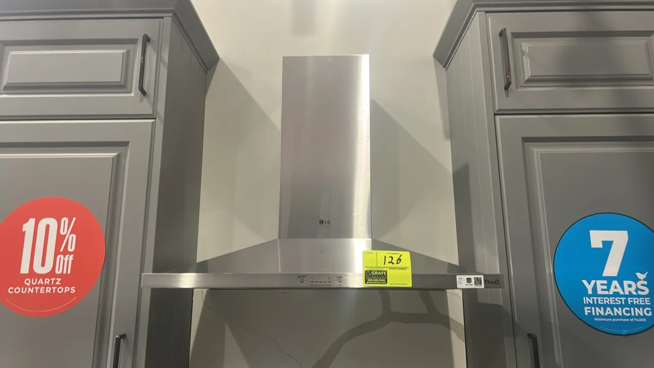 LG Studio LSHD3080ST wall-mount chimney range hood. Features stainless steel construction, chimney duct cover, front push-button controls, and LG Thin