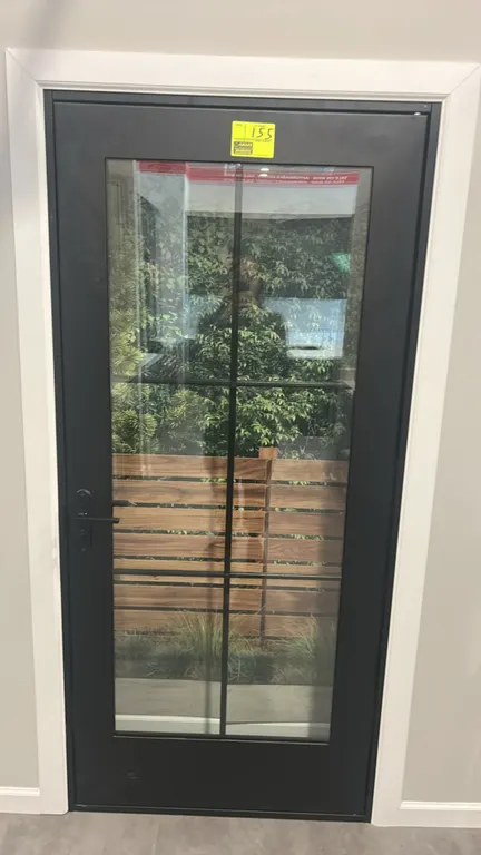 Glass panel metal door. Features a black finish, full glass panel with 6-lite grille pattern, and black lever handle hardware. 38"W x 82"H.