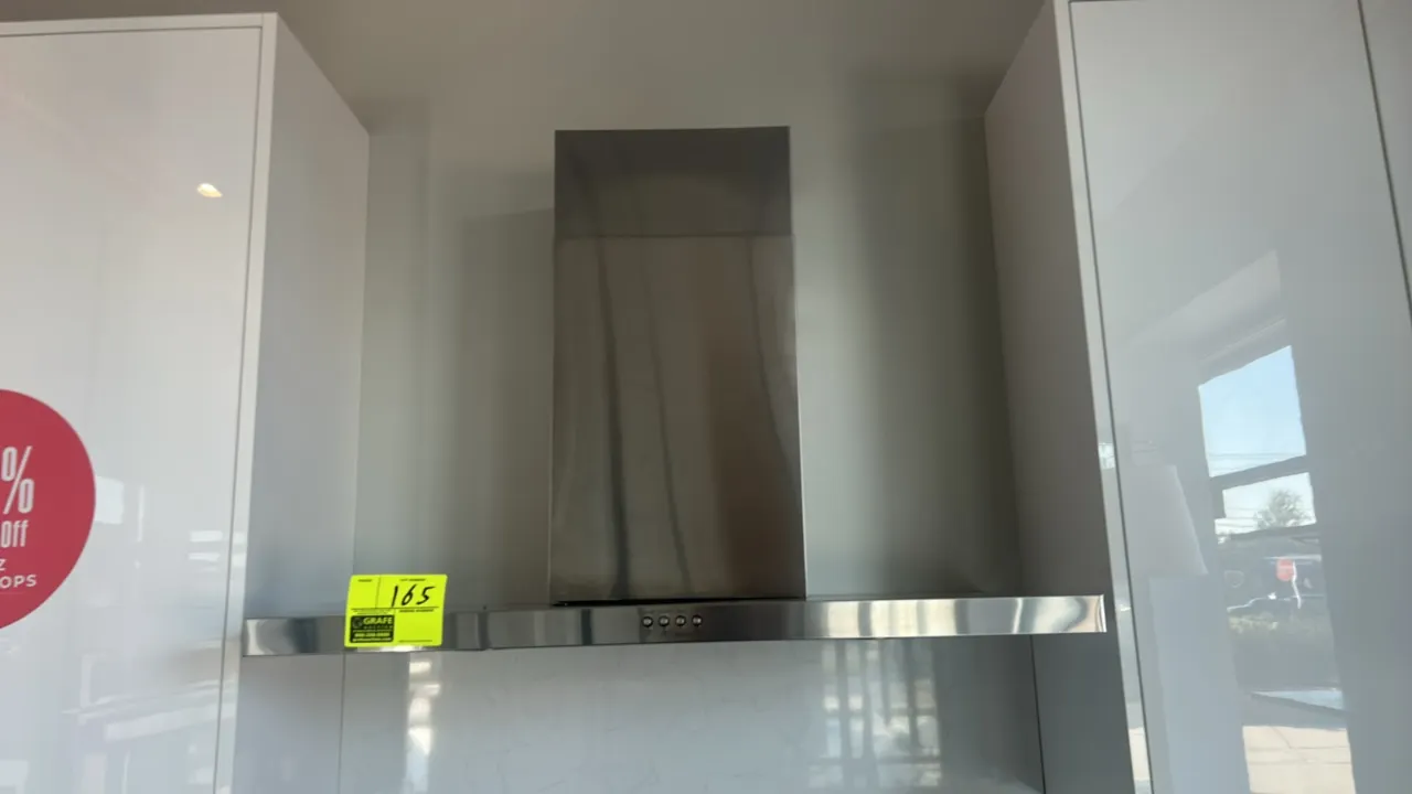 Whirlpool WVW57UC6FS3 wall-mount flat range hood. Features stainless steel construction, chimney flue, push-button controls, and integrated underside